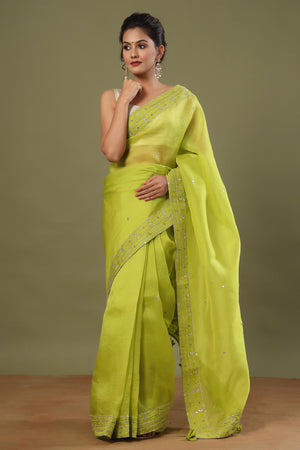 Buy pista green organza sari online in USA with embroidered border. Make a fashion statement at weddings with stunning designer sarees, embroidered sarees with blouse, wedding sarees, handloom sarees from Pure Elegance Indian fashion store in USA.-front