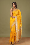 Buy stunning mango yellow Banarasi sari online in USA with zari jaal. Make a fashion statement at weddings with stunning designer sarees, embroidered sarees with blouse, wedding sarees, handloom sarees from Pure Elegance Indian fashion store in USA.-full view