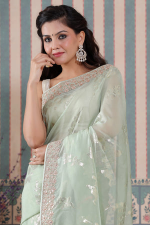 Shop beautiful pastel green embroidered organza silk sari online in USA. Make a fashion statement at weddings with stunning designer sarees, embroidered sarees with blouse, wedding sarees, handloom sarees from Pure Elegance Indian fashion store in USA.-closeup
