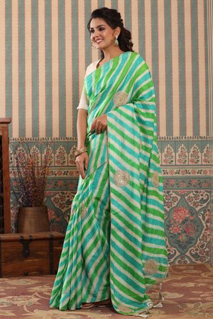 Buy green striped tussar silk sari online in USA with saree blouse.. Make a fashion statement at weddings with stunning designer sarees, embroidered sarees with blouse, wedding sarees, handloom sarees from Pure Elegance Indian fashion store in USA.-pallu
