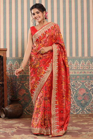 Buy orange Patola silk sari online in USA with embroidered zari border. Make a fashion statement at weddings with stunning designer sarees, embroidered sarees with blouse, wedding sarees, handloom sarees from Pure Elegance Indian fashion store in USA.-front