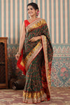 Buy dark green Patola silk sari online in USA with embroidered zari border. Make a fashion statement at weddings with stunning designer sarees, embroidered sarees with blouse, wedding sarees, handloom sarees from Pure Elegance Indian fashion store in USA.-full view