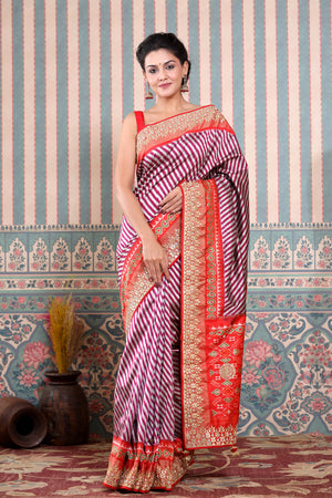 Shop maroon and silver Patola silk sari online in USA with embroidered border. Make a fashion statement at weddings with stunning designer sarees, embroidered sarees with blouse, wedding sarees, handloom sarees from Pure Elegance Indian fashion store in USA.-saree