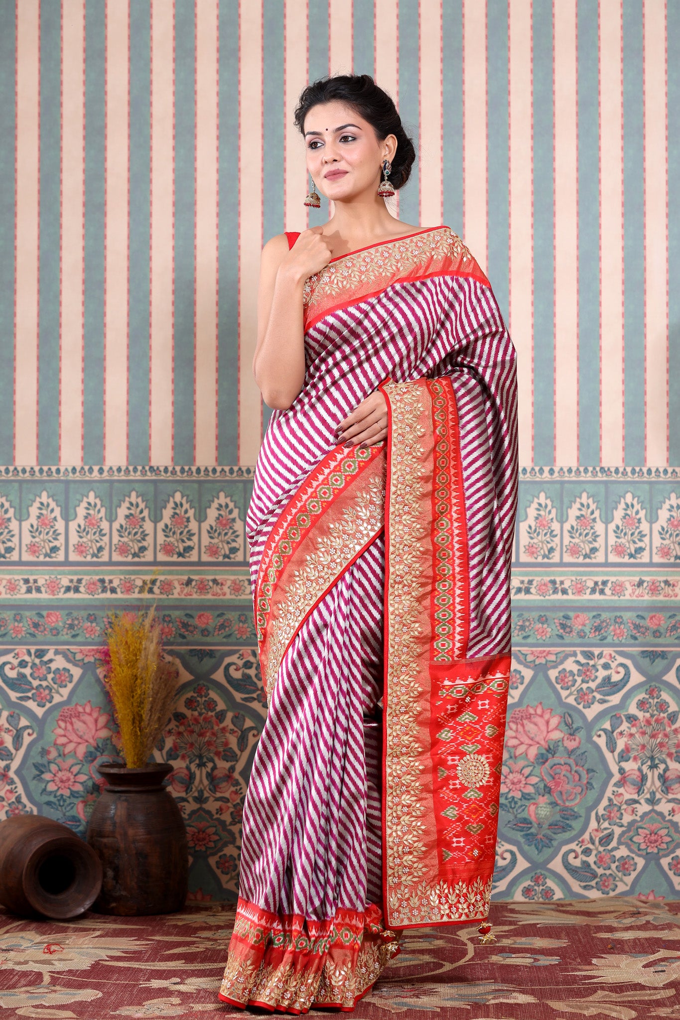 Shop maroon and silver Patola silk sari online in USA with embroidered border. Make a fashion statement at weddings with stunning designer sarees, embroidered sarees with blouse, wedding sarees, handloom sarees from Pure Elegance Indian fashion store in USA.-front