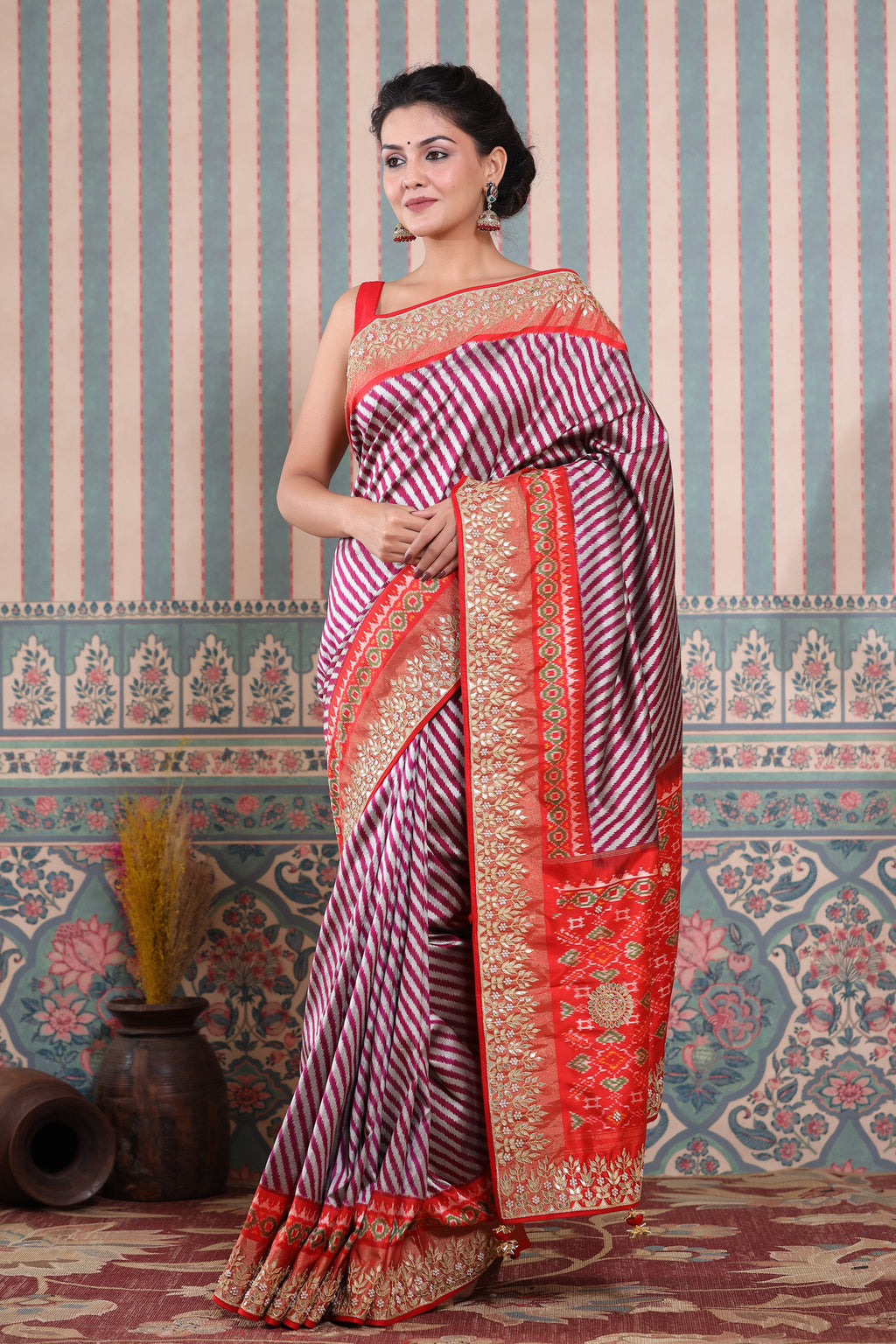 Shop maroon and silver Patola silk sari online in USA with embroidered border. Make a fashion statement at weddings with stunning designer sarees, embroidered sarees with blouse, wedding sarees, handloom sarees from Pure Elegance Indian fashion store in USA.-full view