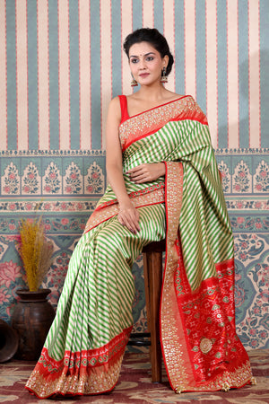 Buy green and cream Patola silk sari online in USA with embroidered border. Make a fashion statement at weddings with stunning designer sarees, embroidered sarees with blouse, wedding sarees, handloom sarees from Pure Elegance Indian fashion store in USA.-saree