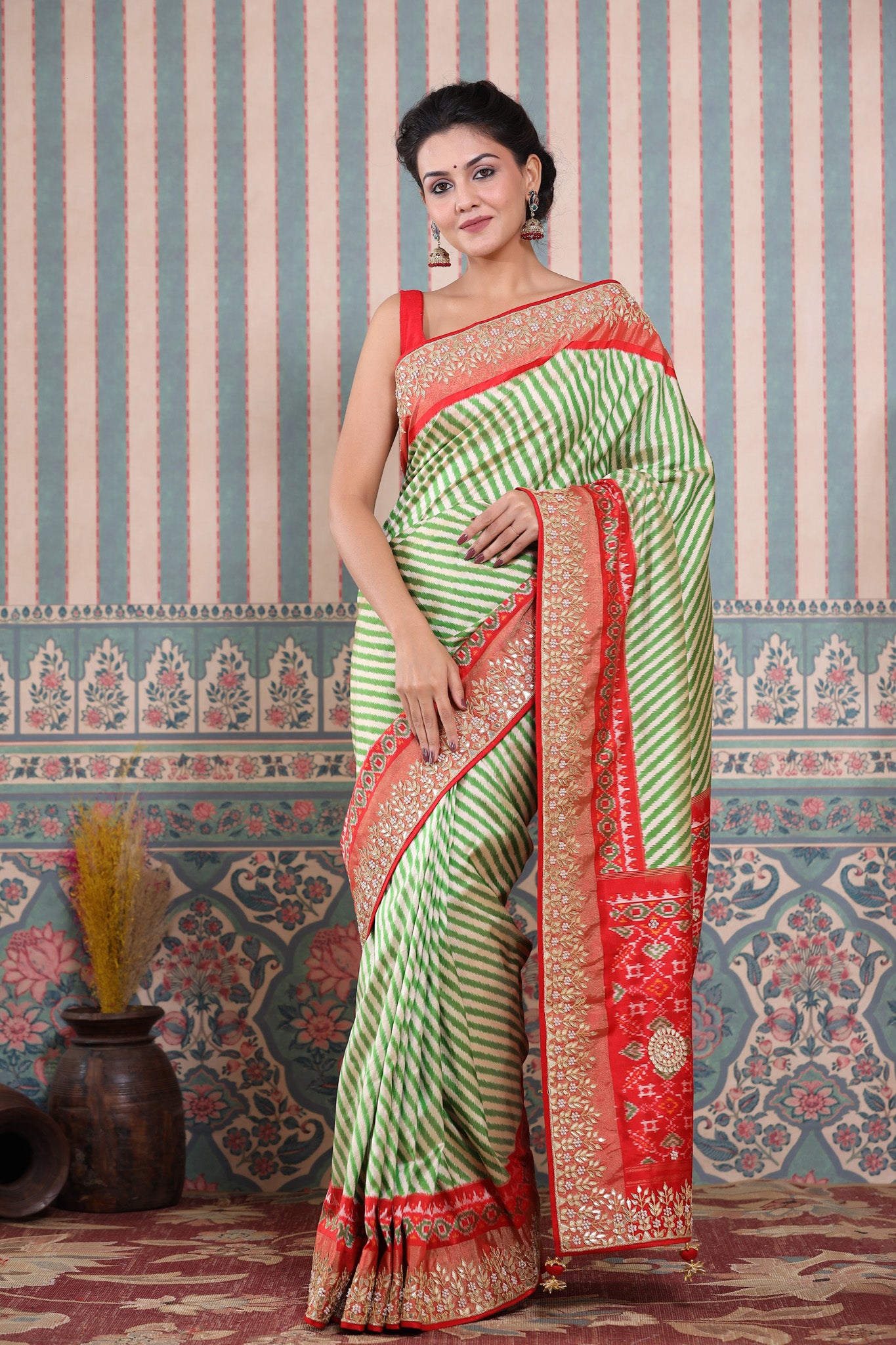 Buy green and cream Patola silk sari online in USA with embroidered border. Make a fashion statement at weddings with stunning designer sarees, embroidered sarees with blouse, wedding sarees, handloom sarees from Pure Elegance Indian fashion store in USA.-front