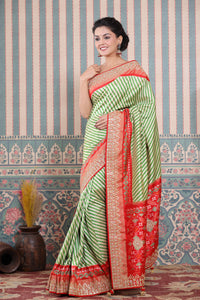 Buy green and cream Patola silk sari online in USA with embroidered border. Make a fashion statement at weddings with stunning designer sarees, embroidered sarees with blouse, wedding sarees, handloom sarees from Pure Elegance Indian fashion store in USA.-full view