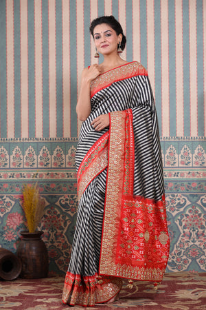 Buy black and grey Patola silk sari online in USA with embroidered border. Make a fashion statement at weddings with stunning designer sarees, embroidered sarees with blouse, wedding sarees, handloom sarees from Pure Elegance Indian fashion store in USA.-pallu