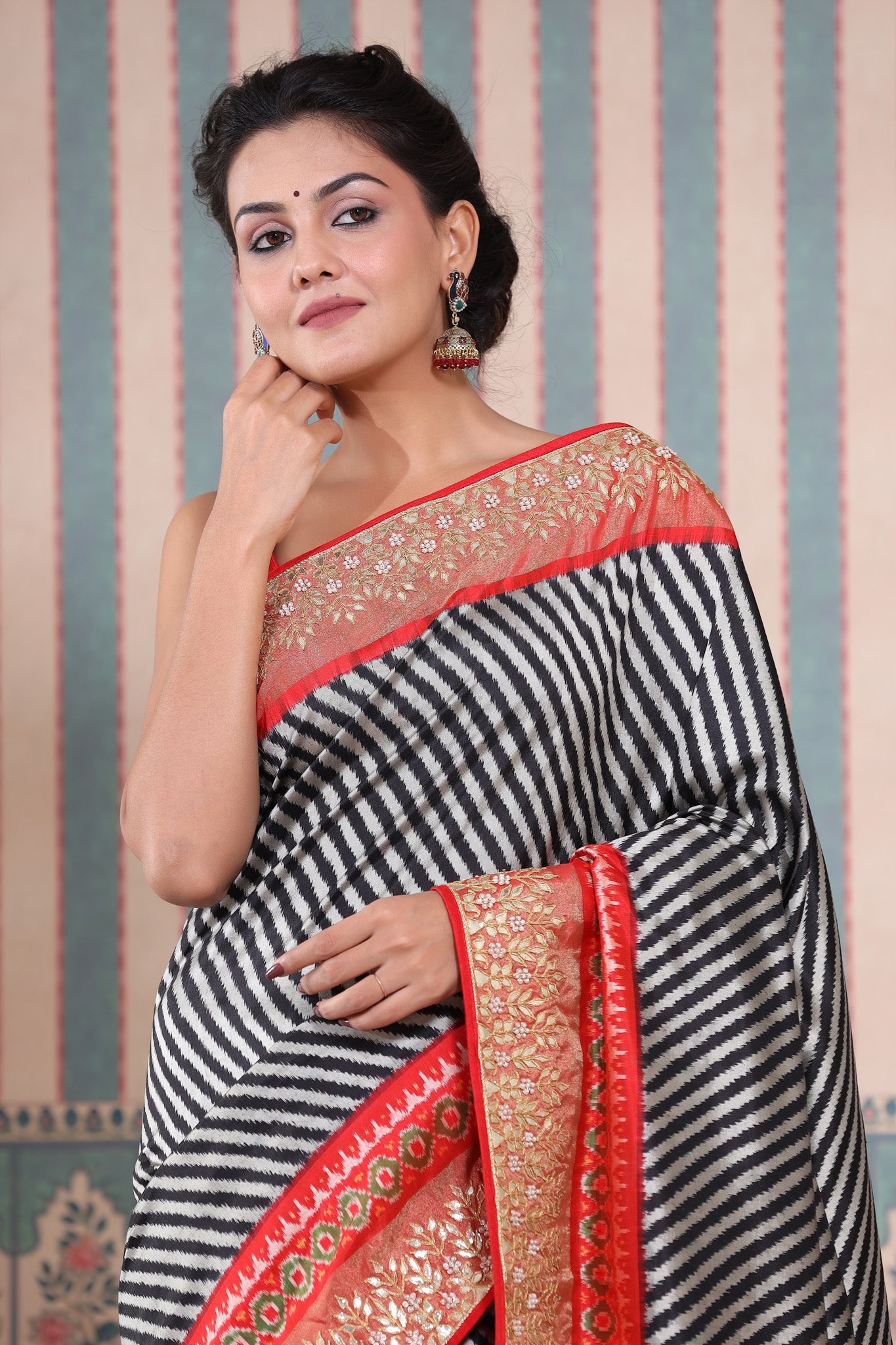 Buy black and grey Patola silk sari online in USA with embroidered border. Make a fashion statement at weddings with stunning designer sarees, embroidered sarees with blouse, wedding sarees, handloom sarees from Pure Elegance Indian fashion store in USA.-closeup