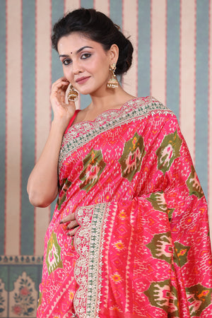 Buy pink Patola silk sari online in USA with embroidered scalloped border. Make a fashion statement at weddings with stunning designer sarees, embroidered sarees with blouse, wedding sarees, handloom sarees from Pure Elegance Indian fashion store in USA.-closeup