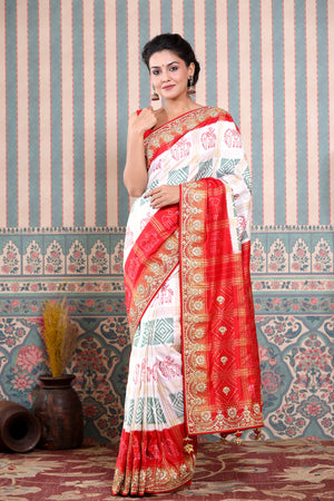 Buy beautiful white Patola silk sari online in USA with red embroidered border. Make a fashion statement at weddings with stunning designer sarees, embroidered sarees with blouse, wedding sarees, handloom sarees from Pure Elegance Indian fashion store in USA.-front
