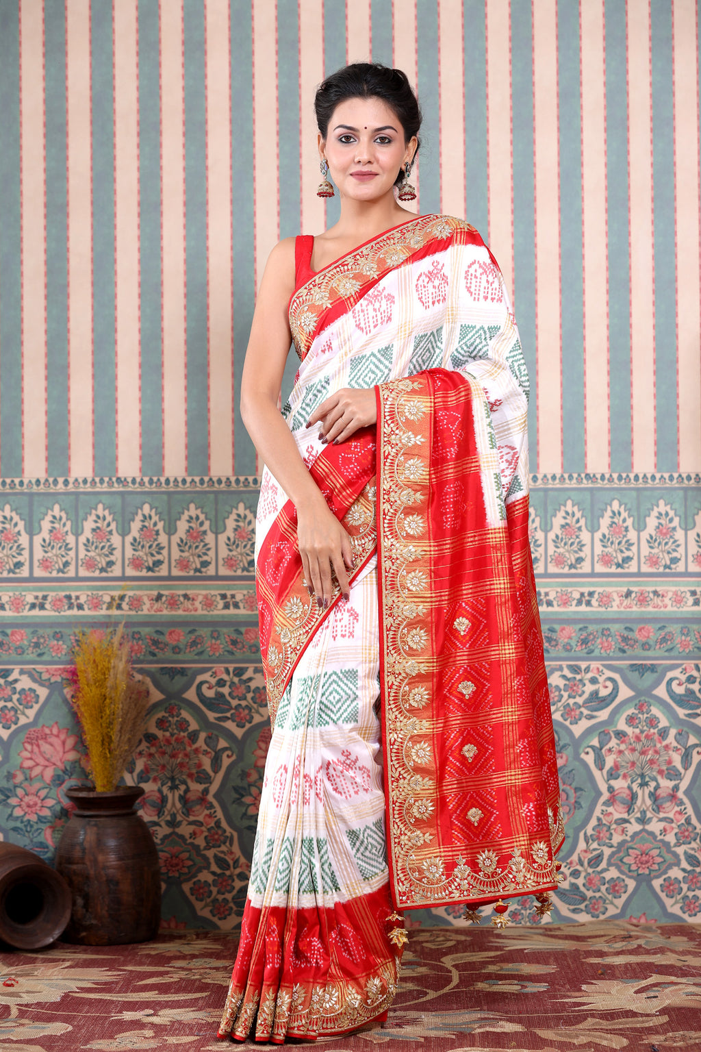 Buy beautiful white Patola silk sari online in USA with red embroidered border. Make a fashion statement at weddings with stunning designer sarees, embroidered sarees with blouse, wedding sarees, handloom sarees from Pure Elegance Indian fashion store in USA.-full view