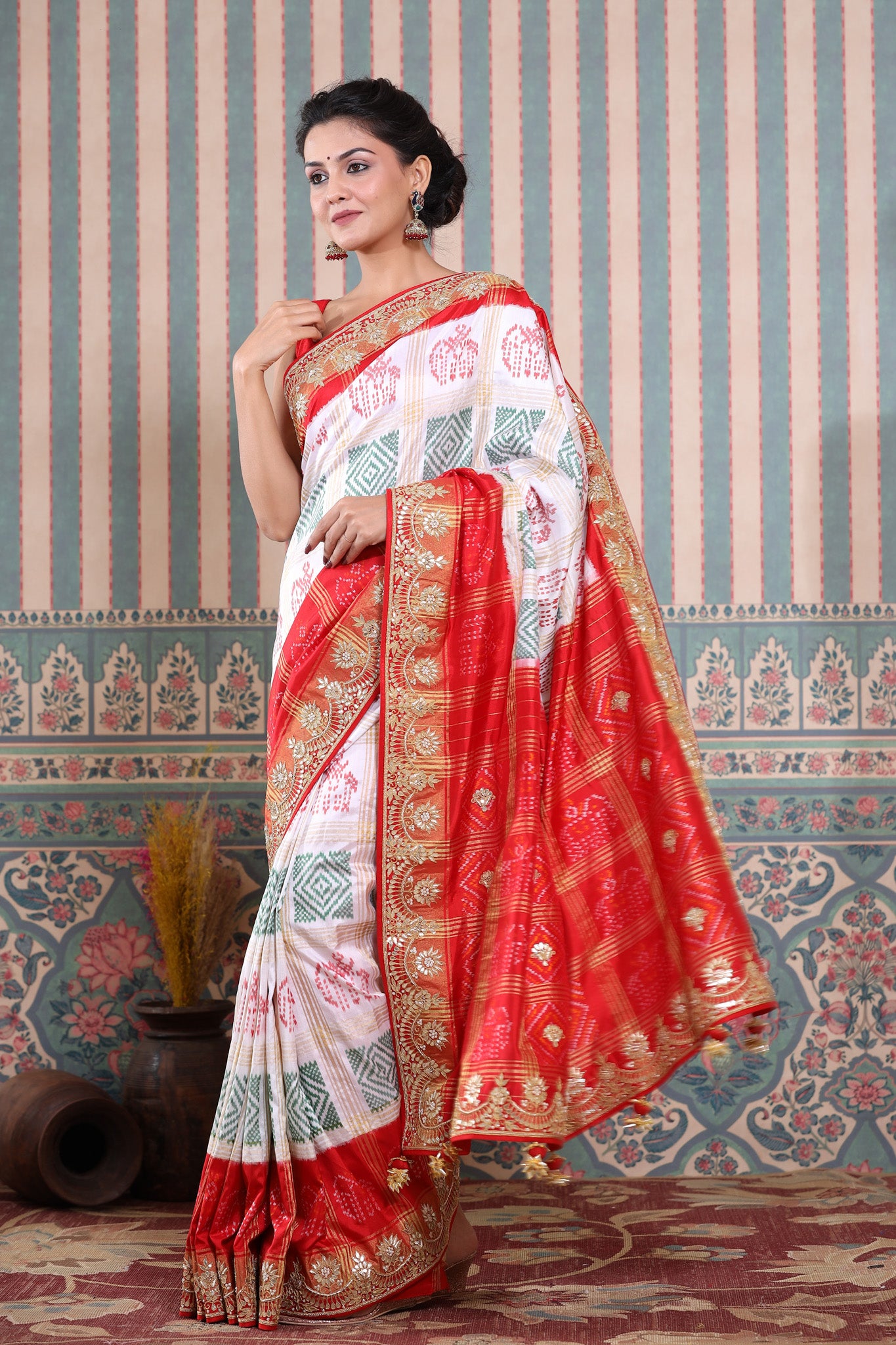 Buy beautiful white Patola silk sari online in USA with red embroidered border. Make a fashion statement at weddings with stunning designer sarees, embroidered sarees with blouse, wedding sarees, handloom sarees from Pure Elegance Indian fashion store in USA.-pallu