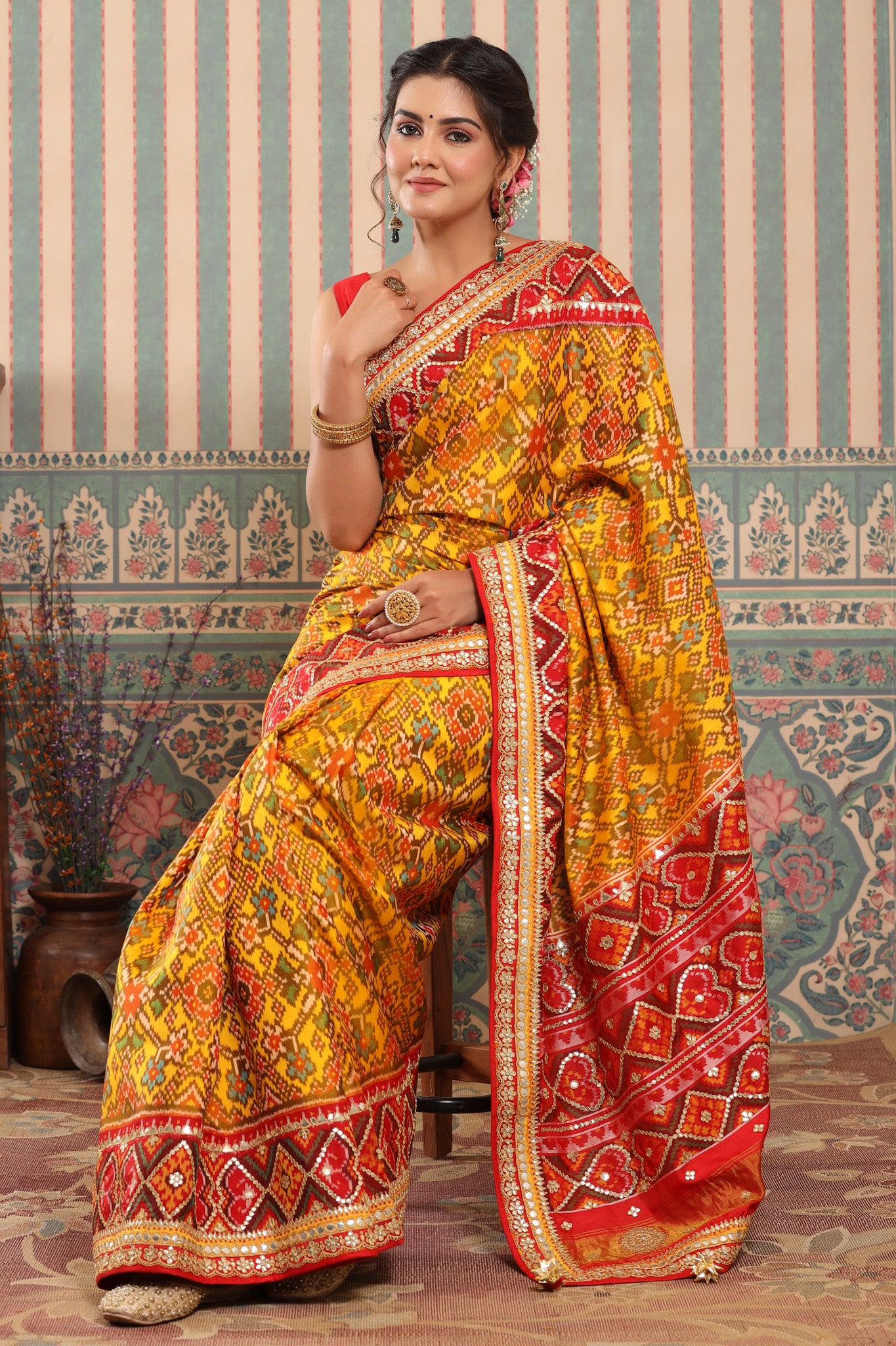Buy yellow Patola silk sari online in USA with red embroidered border. Make a fashion statement at weddings with stunning designer sarees, embroidered sarees with blouse, wedding sarees, handloom sarees from Pure Elegance Indian fashion store in USA.-Patola