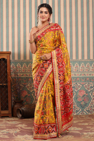 Buy yellow Patola silk sari online in USA with red embroidered border. Make a fashion statement at weddings with stunning designer sarees, embroidered sarees with blouse, wedding sarees, handloom sarees from Pure Elegance Indian fashion store in USA.-saree