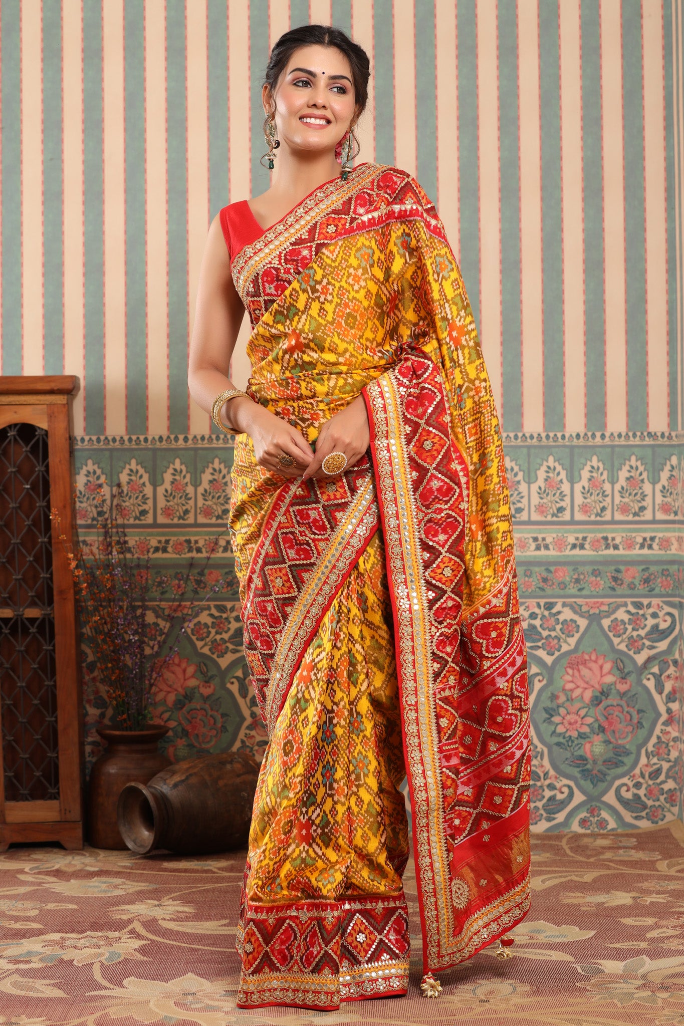 Buy yellow Patola silk sari online in USA with red embroidered border. Make a fashion statement at weddings with stunning designer sarees, embroidered sarees with blouse, wedding sarees, handloom sarees from Pure Elegance Indian fashion store in USA.-front
