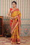 Buy yellow Patola silk sari online in USA with red embroidered border. Make a fashion statement at weddings with stunning designer sarees, embroidered sarees with blouse, wedding sarees, handloom sarees from Pure Elegance Indian fashion store in USA.-full view