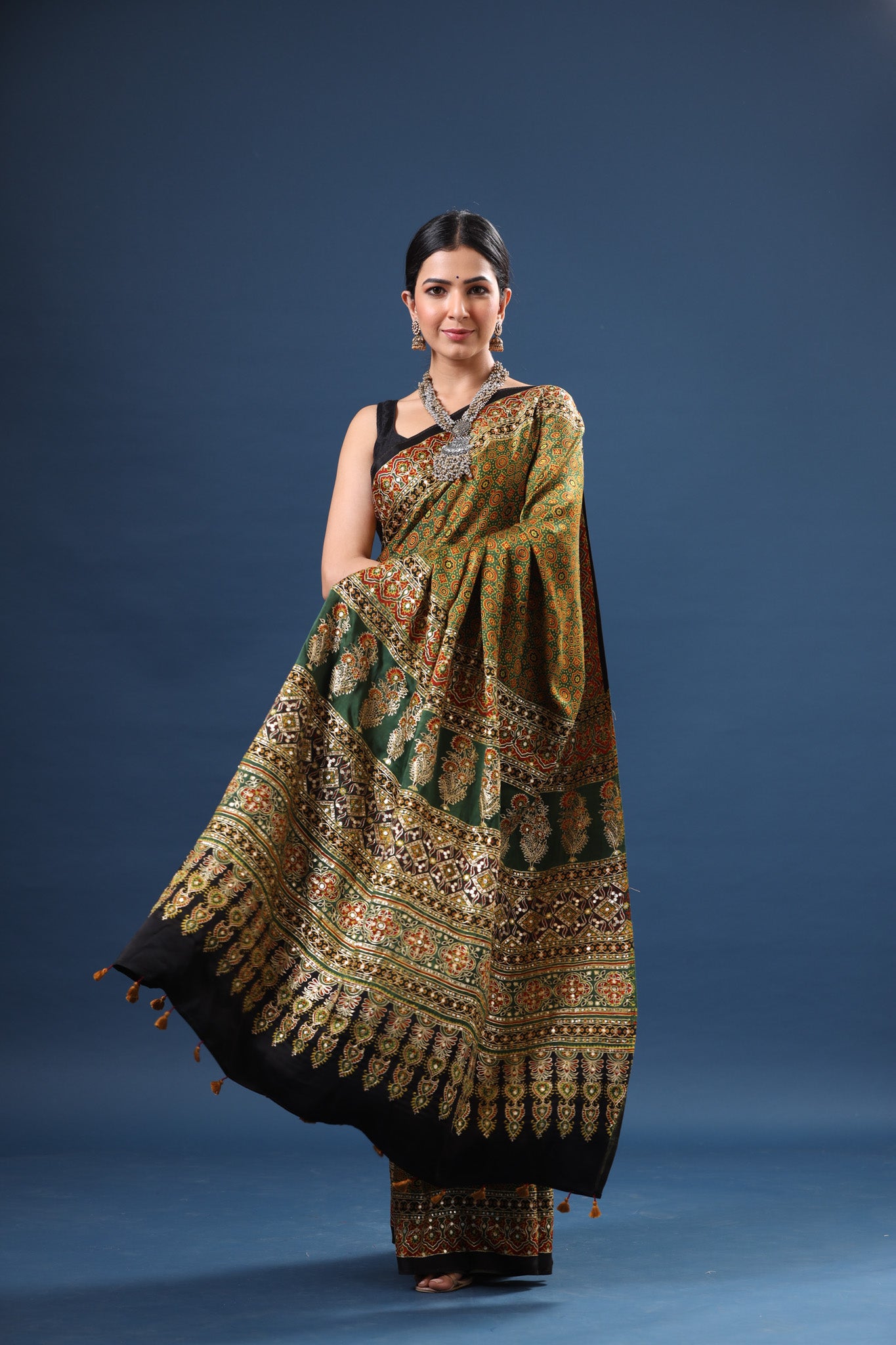 Buy beautiful mehendi green Ajrakh print modal silk sari online in USA. Make a fashion statement at weddings with stunning designer sarees, embroidered sarees with blouse, wedding sarees, handloom sarees from Pure Elegance Indian fashion store in USA.-front