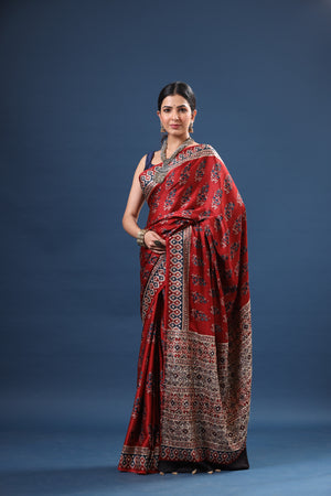 Shop stunning red Ajrakh print modal silk sari online in USA. Make a fashion statement at weddings with stunning designer sarees, embroidered sarees with blouse, wedding sarees, handloom sarees from Pure Elegance Indian fashion store in USA.-saree