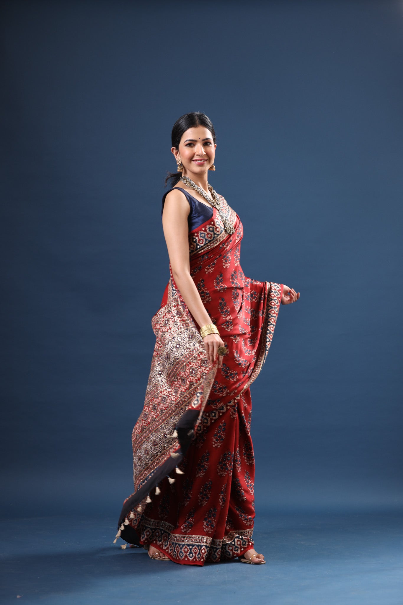 Shop stunning red Ajrakh print modal silk sari online in USA. Make a fashion statement at weddings with stunning designer sarees, embroidered sarees with blouse, wedding sarees, handloom sarees from Pure Elegance Indian fashion store in USA.-side