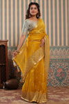 Buy yellow organza silk sari online in USA with green embroidered blouse. Make a fashion statement at weddings with stunning designer sarees, embroidered sarees with blouse, wedding sarees, handloom sarees from Pure Elegance Indian fashion store in USA.-full view