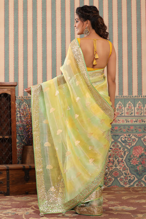 Buy yellow and green organza sari online in USA with gota patti border. Make a fashion statement at weddings with stunning designer sarees, embroidered sarees with blouse, wedding sarees, handloom sarees from Pure Elegance Indian fashion store in USA.-back