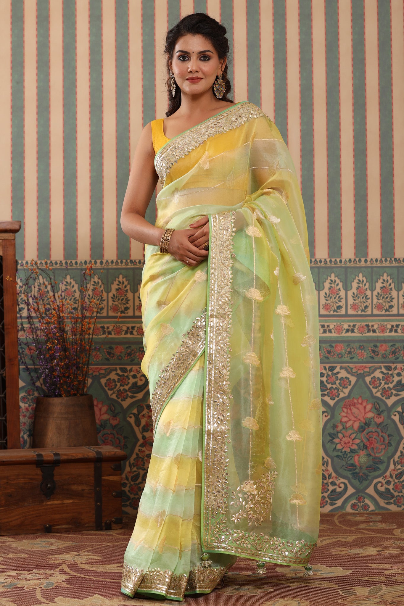 Buy yellow and green organza sari online in USA with gota patti border. Make a fashion statement at weddings with stunning designer sarees, embroidered sarees with blouse, wedding sarees, handloom sarees from Pure Elegance Indian fashion store in USA.-front