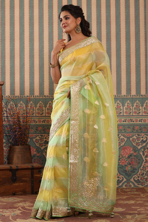Buy yellow and green organza sari online in USA with gota patti border. Make a fashion statement at weddings with stunning designer sarees, embroidered sarees with blouse, wedding sarees, handloom sarees from Pure Elegance Indian fashion store in USA.-pallu