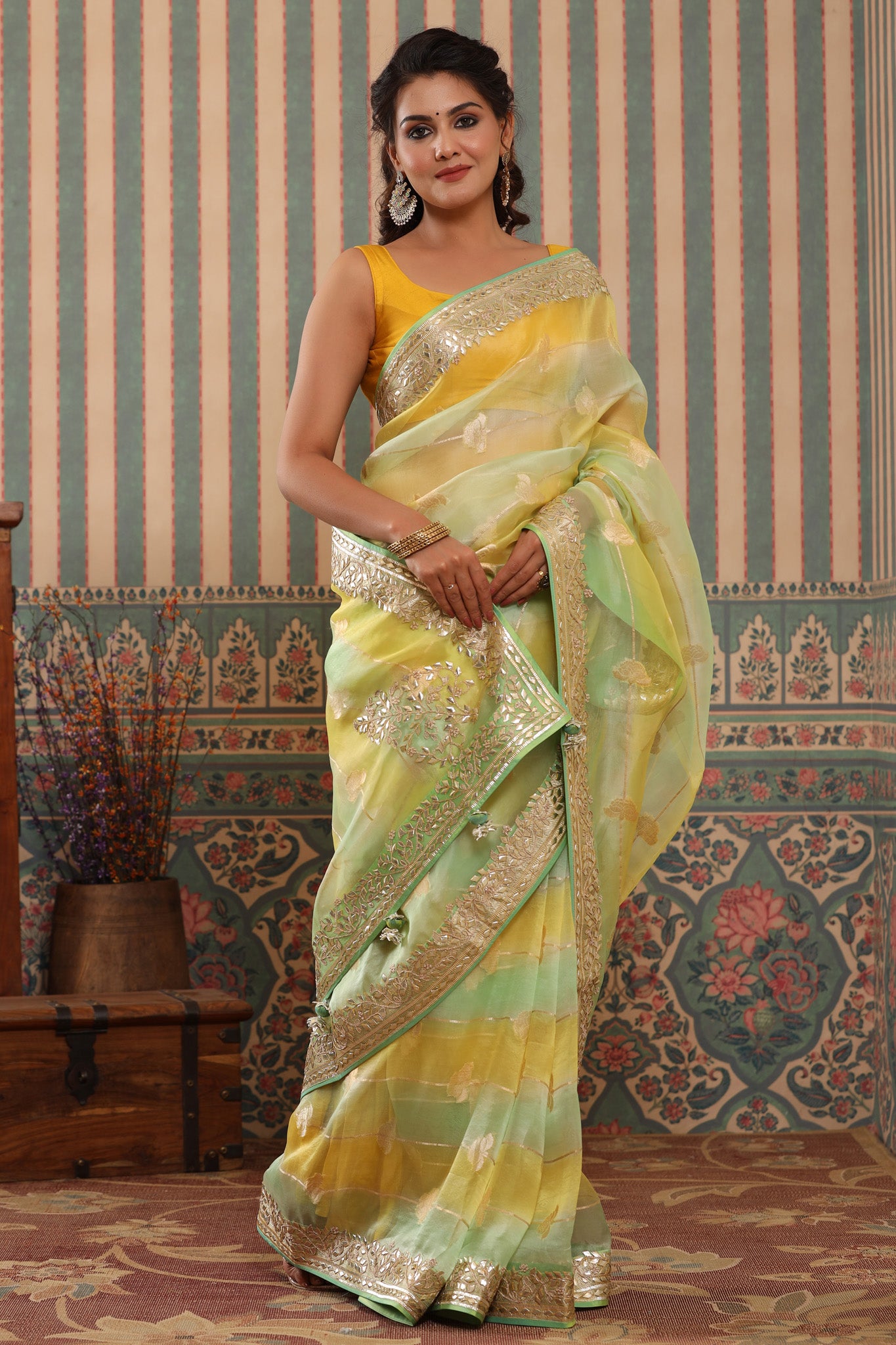 Buy yellow and green organza sari online in USA with gota patti border. Make a fashion statement at weddings with stunning designer sarees, embroidered sarees with blouse, wedding sarees, handloom sarees from Pure Elegance Indian fashion store in USA.-full view
