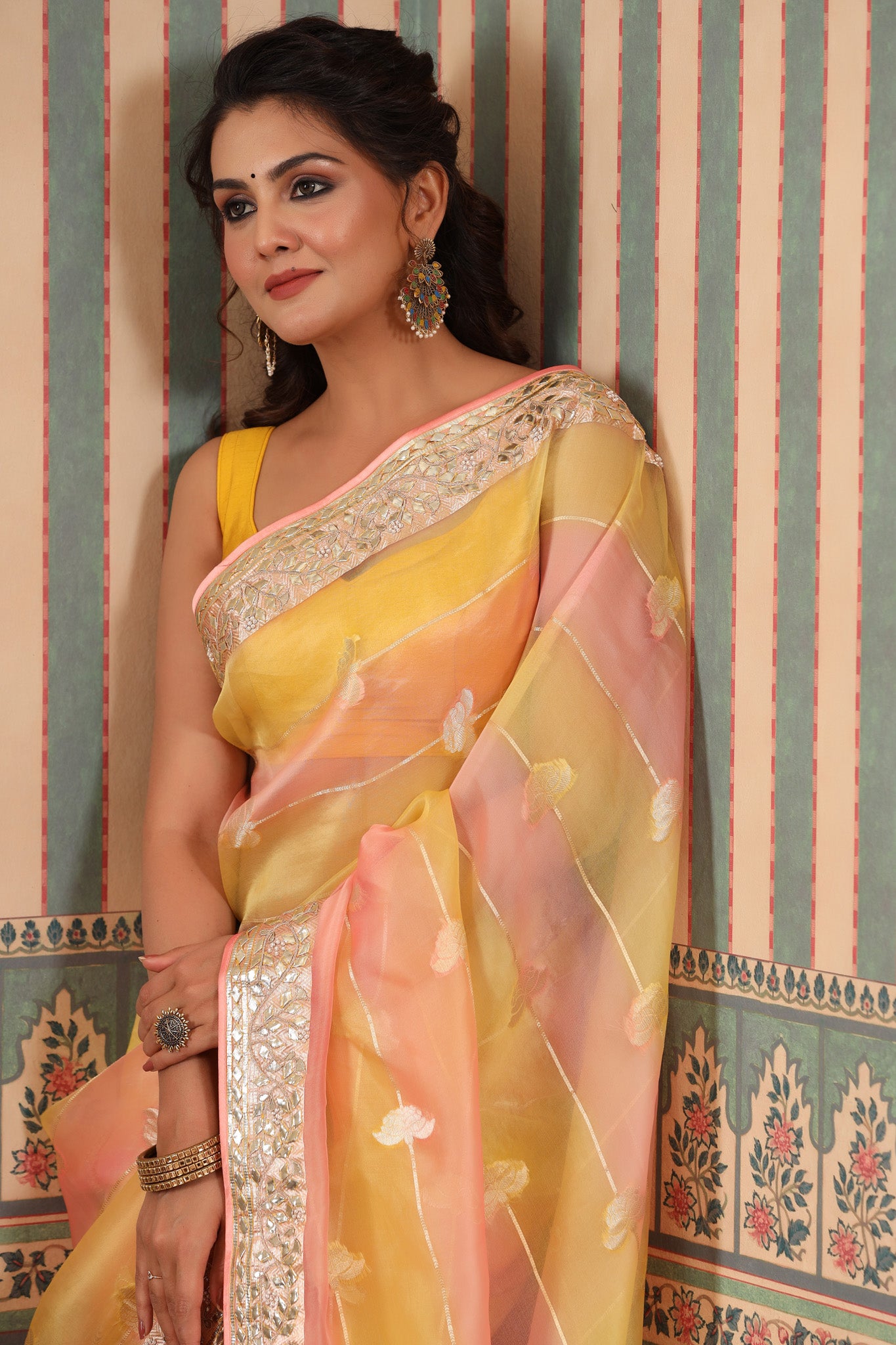 Shop beautiful yellow and peach organza sari online in USA with gota patti border. Make a fashion statement at weddings with stunning designer sarees, embroidered sarees with blouse, wedding sarees, handloom sarees from Pure Elegance Indian fashion store in USA.-closeup