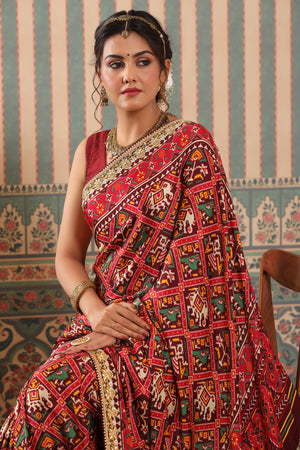 Shop red Patola sari online in USA with embroidered border. Make a fashion statement at weddings with stunning designer sarees, embroidered sarees with blouse, wedding sarees, handloom sarees from Pure Elegance Indian fashion store in USA.-closeup