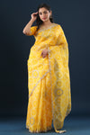 Buy yellow printed organza sari online in USA with embroidered scalloped border. Make a fashion statement at weddings with stunning designer sarees, embroidered sarees with blouse, wedding sarees, handloom sarees from Pure Elegance Indian fashion store in USA.-full view