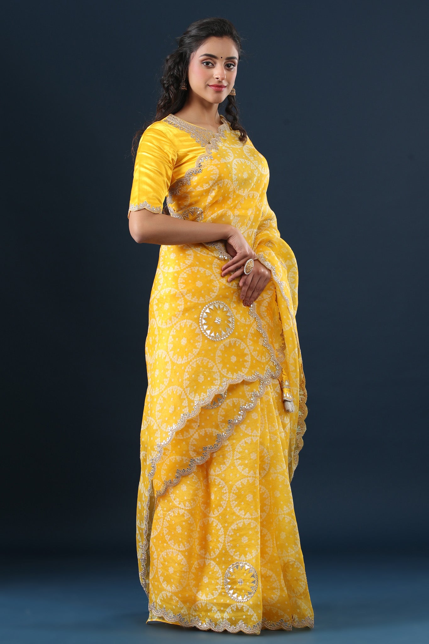 Buy yellow printed organza sari online in USA with embroidered scalloped border. Make a fashion statement at weddings with stunning designer sarees, embroidered sarees with blouse, wedding sarees, handloom sarees from Pure Elegance Indian fashion store in USA.-side