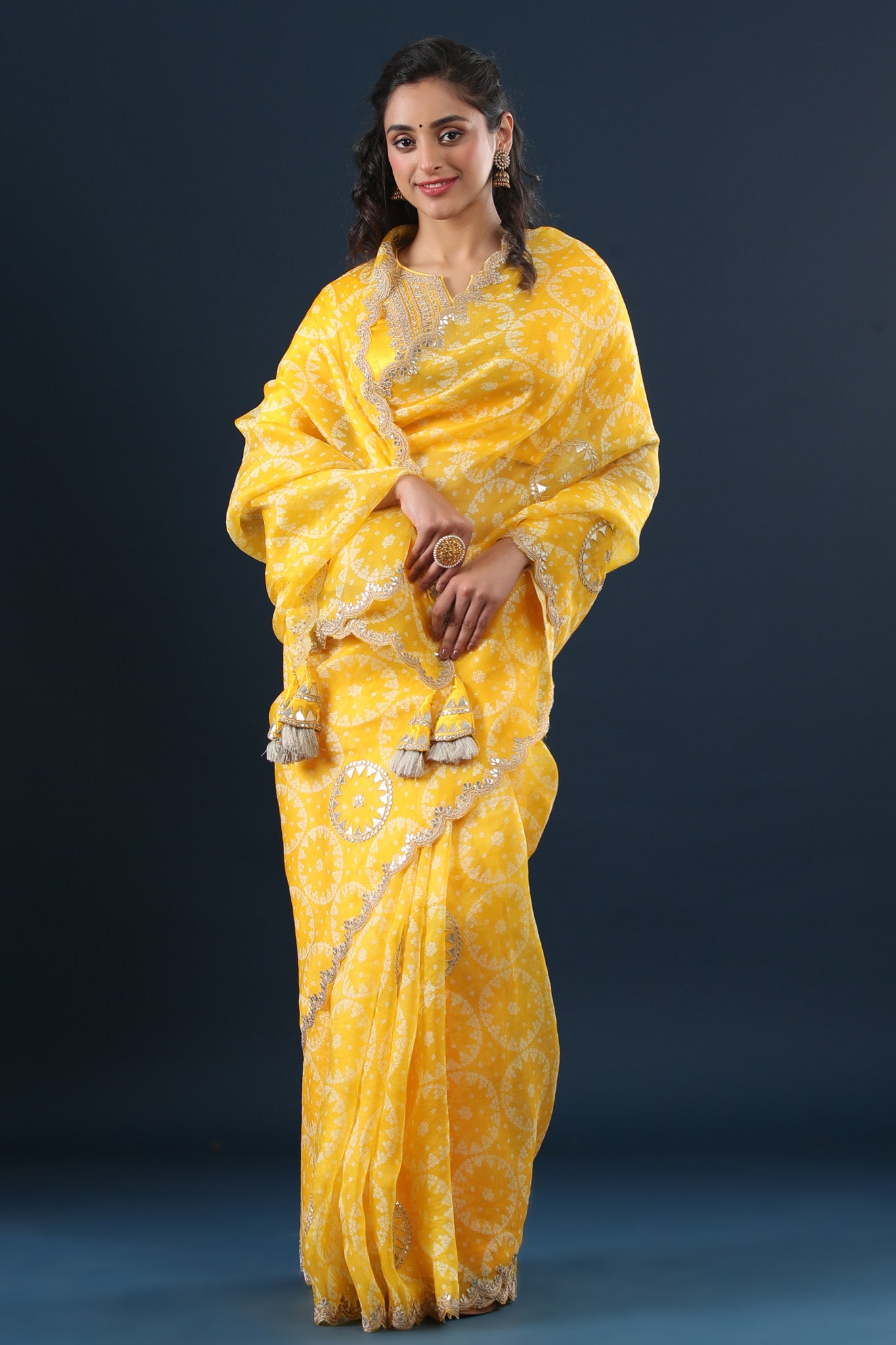Buy yellow printed organza sari online in USA with embroidered scalloped border. Make a fashion statement at weddings with stunning designer sarees, embroidered sarees with blouse, wedding sarees, handloom sarees from Pure Elegance Indian fashion store in USA.-front