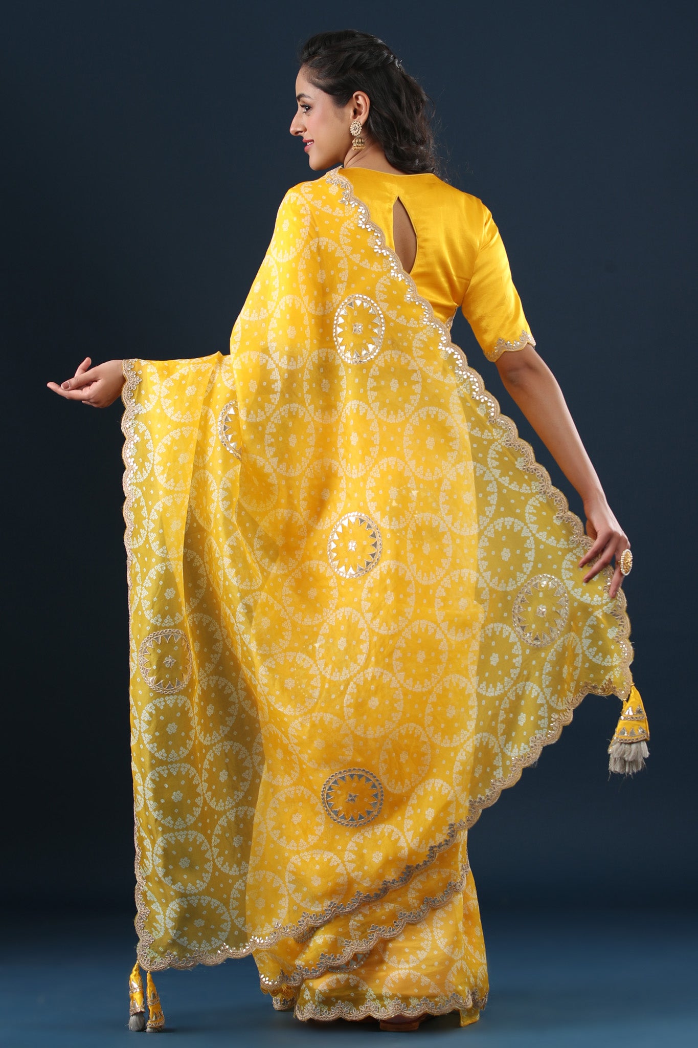 Buy yellow printed organza sari online in USA with embroidered scalloped border. Make a fashion statement at weddings with stunning designer sarees, embroidered sarees with blouse, wedding sarees, handloom sarees from Pure Elegance Indian fashion store in USA.-back