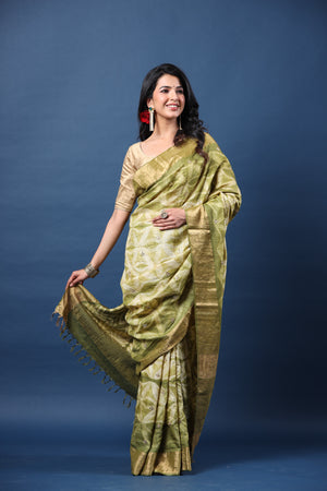 Buy olive green printed tussar silk sari online in USA with golden zari border. Make a fashion statement at weddings with stunning designer sarees, embroidered sarees with blouse, wedding sarees, handloom sarees from Pure Elegance Indian fashion store in USA.-saree