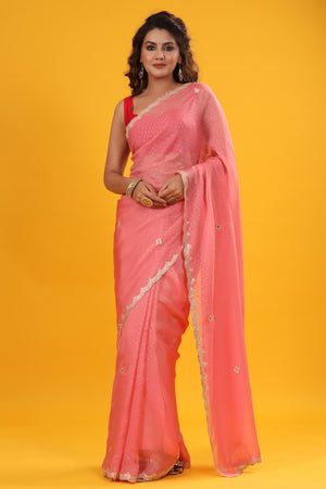 Buy pink organza sari online in USA with embroidered scalloped border. Make a fashion statement at weddings with stunning designer sarees, embroidered sarees with blouse, wedding sarees, handloom sarees from Pure Elegance Indian fashion store in USA.-front