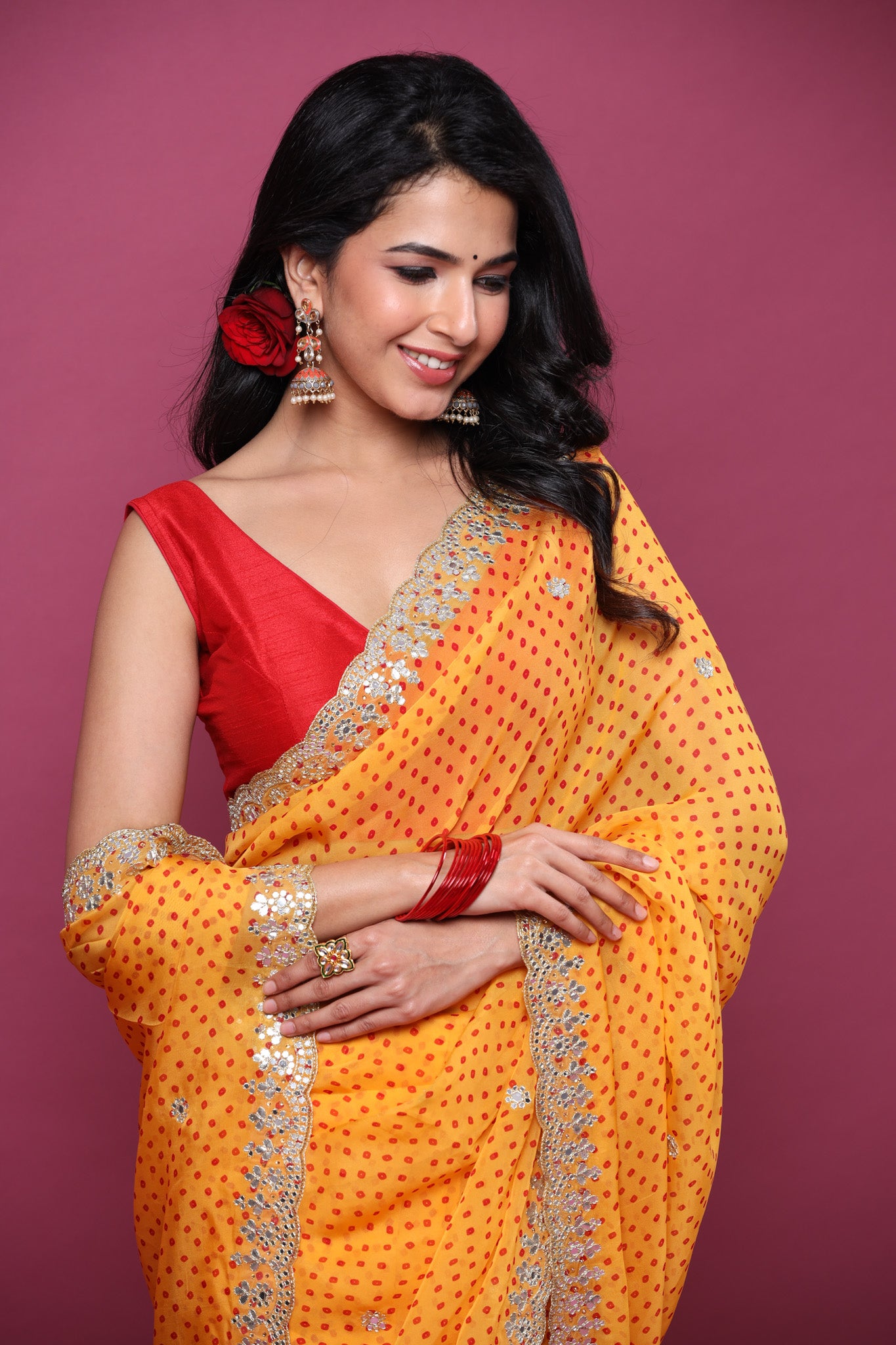 Shop orange bandhej organza sari online in USA with scalloped border. Make a fashion statement at weddings with stunning designer sarees, embroidered sarees with blouse, wedding sarees, handloom sarees from Pure Elegance Indian fashion store in USA.-closeup