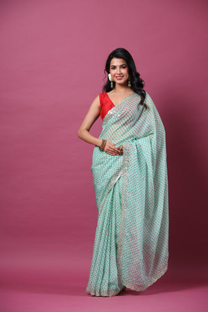 Buy mint green bandhej organza sari online in USA with scalloped border. Make a fashion statement at weddings with stunning designer sarees, embroidered sarees with blouse, wedding sarees, handloom sarees from Pure Elegance Indian fashion store in USA.-saree