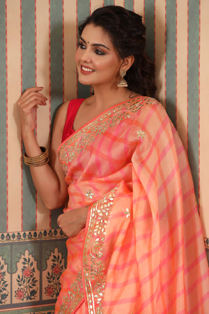 Buy beautiful peach organza sari online in USA with gota patti border. Make a fashion statement at weddings with stunning designer sarees, embroidered sarees with blouse, wedding sarees, handloom sarees from Pure Elegance Indian fashion store in USA.-closeup