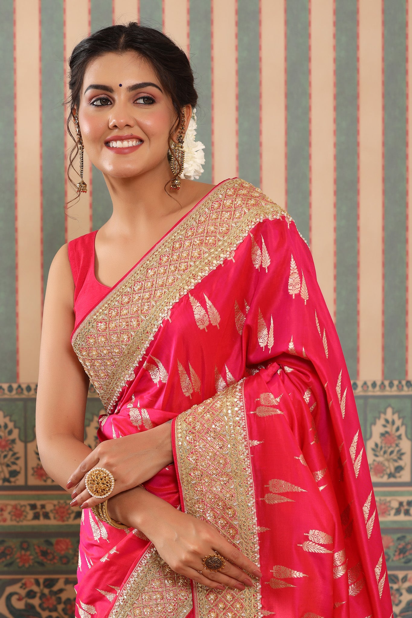 Shop bright pink Banarasi saree online in USA with embroidered border. Make a fashion statement at weddings with stunning designer sarees, embroidered sarees with blouse, wedding sarees, handloom sarees from Pure Elegance Indian fashion store in USA.-closeup