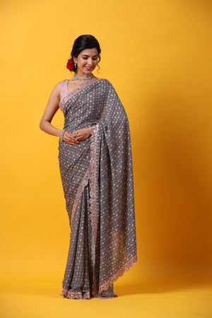 Shop beautiful blue georgette saree online in USA with scalloped border. Make a fashion statement at weddings with stunning designer sarees, embroidered sarees with blouse, wedding sarees, handloom sarees from Pure Elegance Indian fashion store in USA.-front