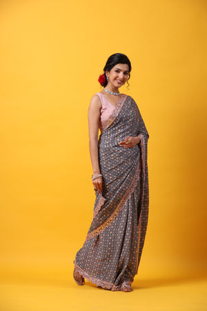 Shop beautiful blue georgette saree online in USA with scalloped border. Make a fashion statement at weddings with stunning designer sarees, embroidered sarees with blouse, wedding sarees, handloom sarees from Pure Elegance Indian fashion store in USA.-side