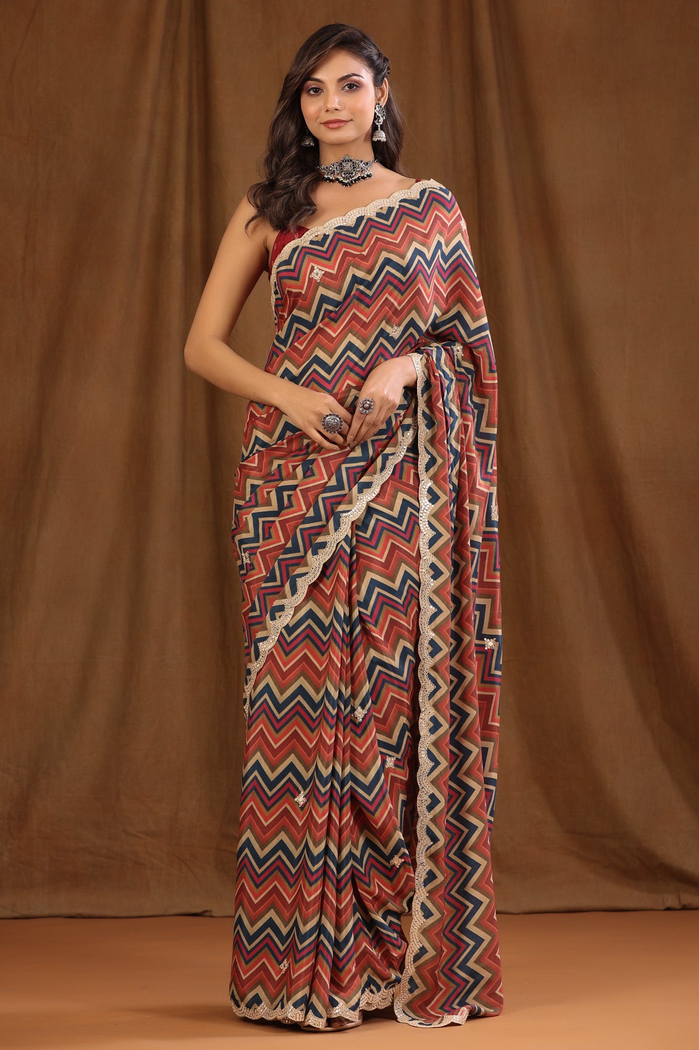 Buy multicolor chevron pattern crepe georgette sari online in USA with embroidered border and blouse. Make a fashion statement at weddings with stunning designer sarees, embroidered sarees with blouse, wedding sarees, handloom sarees from Pure Elegance Indian fashion store in USA.-full view