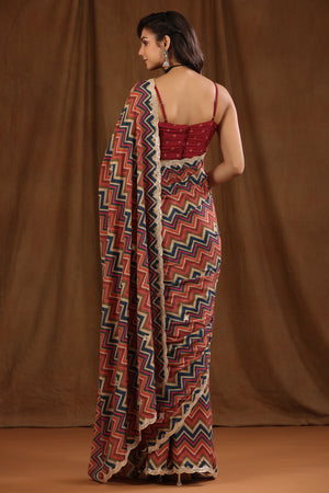 Buy multicolor chevron pattern crepe georgette sari online in USA with embroidered border and blouse. Make a fashion statement at weddings with stunning designer sarees, embroidered sarees with blouse, wedding sarees, handloom sarees from Pure Elegance Indian fashion store in USA.-back