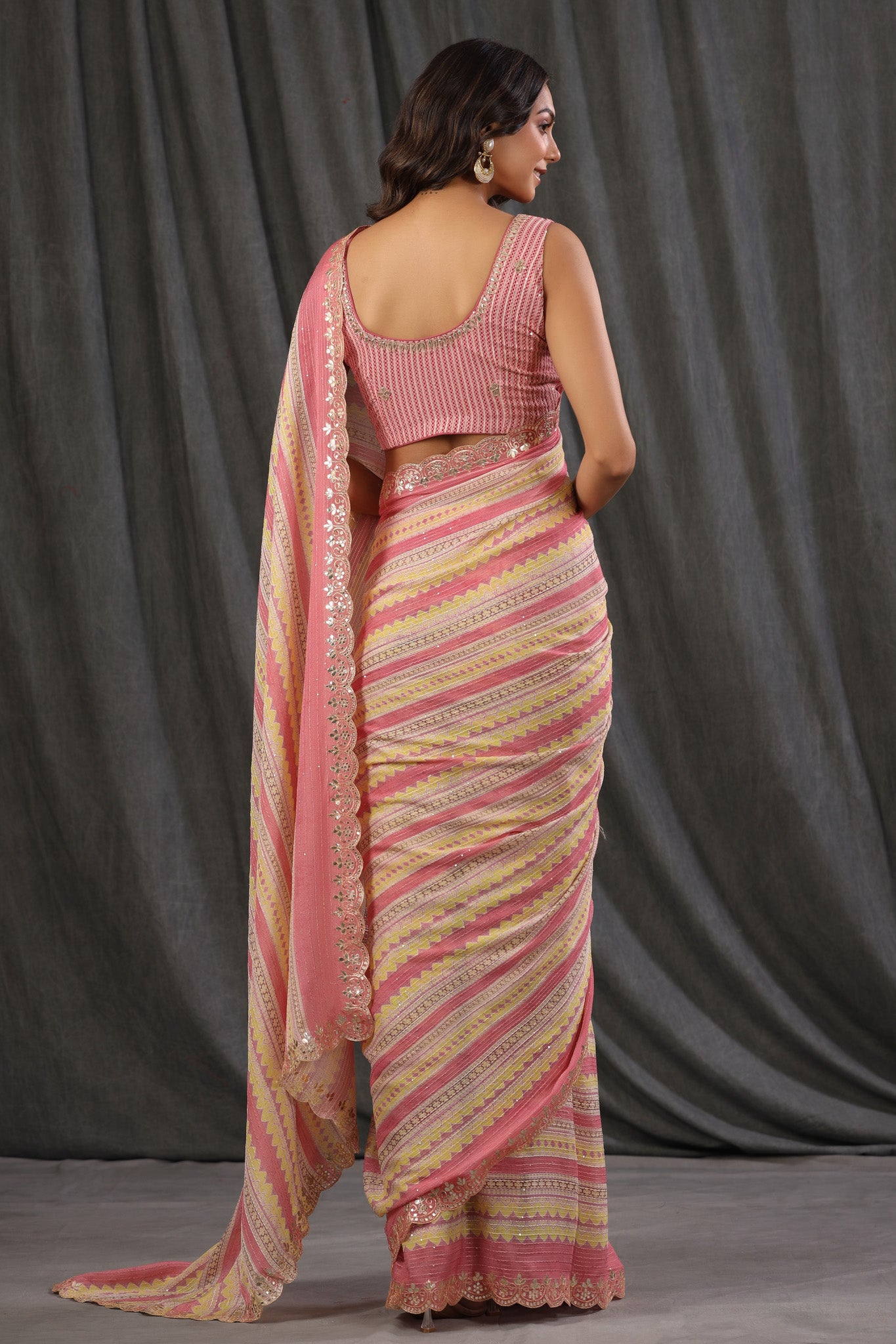 Buy light pink and yellow crepe saree online in USA with embroidered border and blouse. Make a fashion statement at weddings with stunning designer sarees, embroidered sarees with blouse, wedding sarees, handloom sarees from Pure Elegance Indian fashion store in USA.-back
