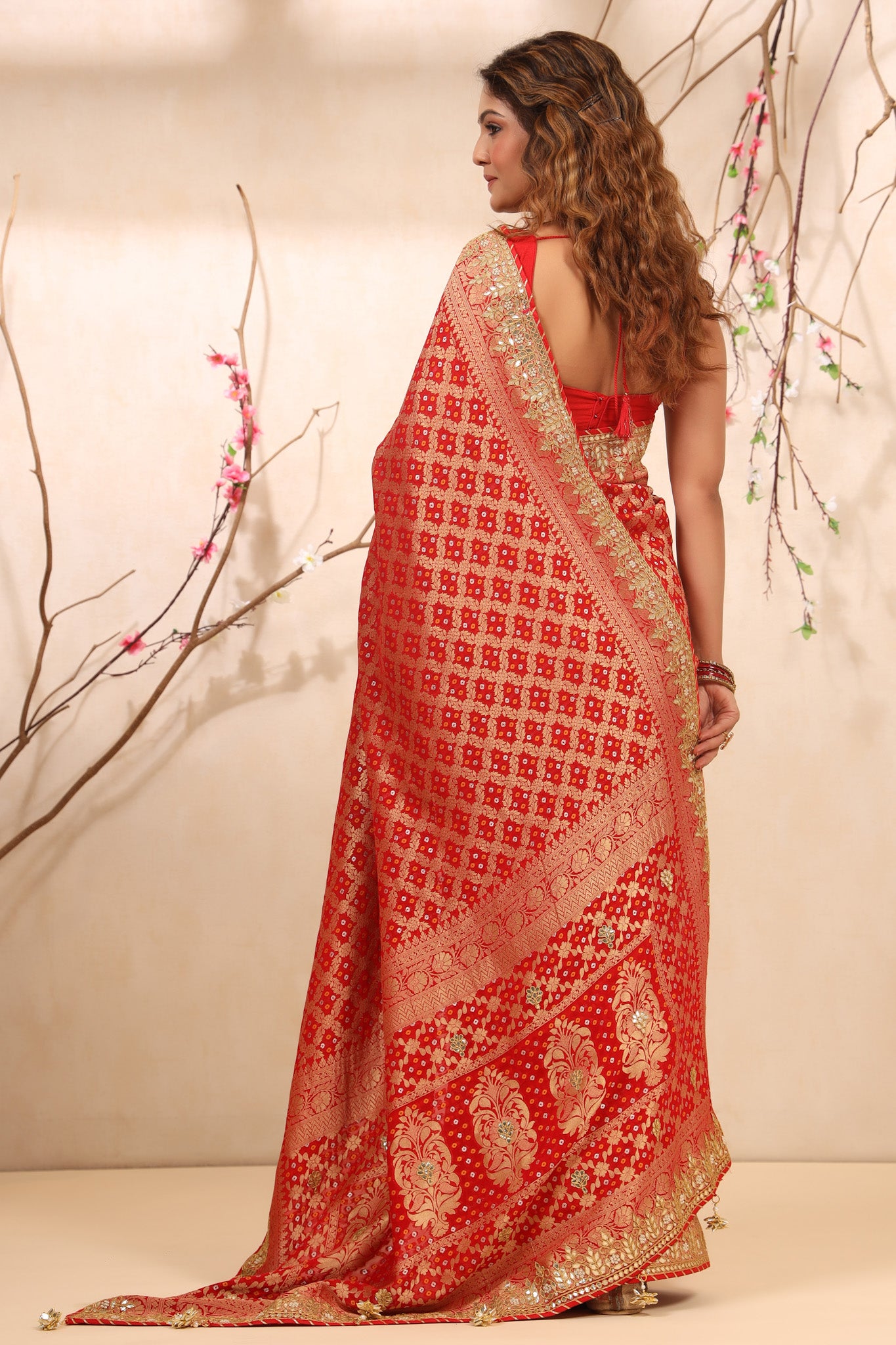 Buy beautiful red bandhej Banarasi saree online in USA with gota patti border. Make a fashion statement at weddings with stunning designer sarees, embroidered sarees with blouse, wedding sarees, handloom sarees from Pure Elegance Indian fashion store in USA.-back