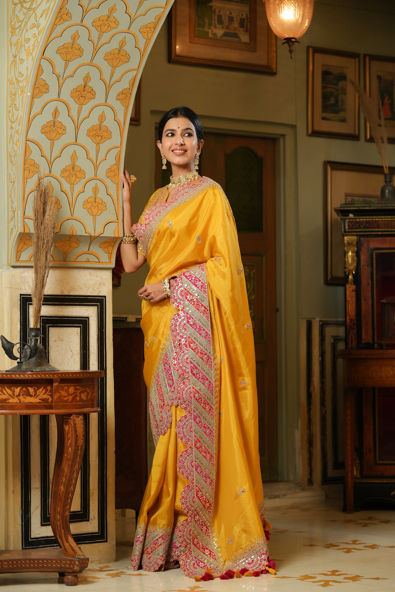 Buy yellow silk saree online in USA with heavy embroidery scalloped border. Make a fashion statement at weddings with stunning designer sarees, embroidered sarees with blouse, wedding sarees, handloom sarees from Pure Elegance Indian fashion store in USA.-pallu