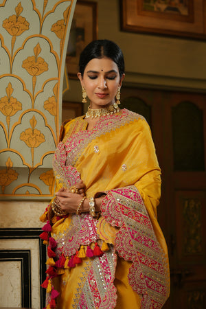 Buy yellow silk saree online in USA with heavy embroidery scalloped border. Make a fashion statement at weddings with stunning designer sarees, embroidered sarees with blouse, wedding sarees, handloom sarees from Pure Elegance Indian fashion store in USA.-closeup